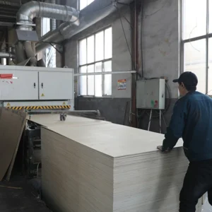 Cutting and sanding process for engineered wood panels during production.
