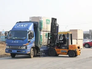 wood factory operations: office desk, exterior building, sanding machinery, veneer rolling, and the automated production line.