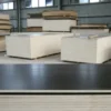 Wholesale film faced plywood sheets stacked in a warehouse for bulk construction and concrete formwork projects.