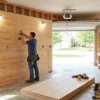 Garage walls lined with plywood for storage, shelving, cabinets, hooks, and workshop applications.