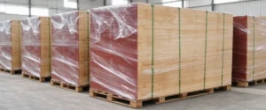 Plywood export packaging with protective wrapping, corner guards and pallet strapping
