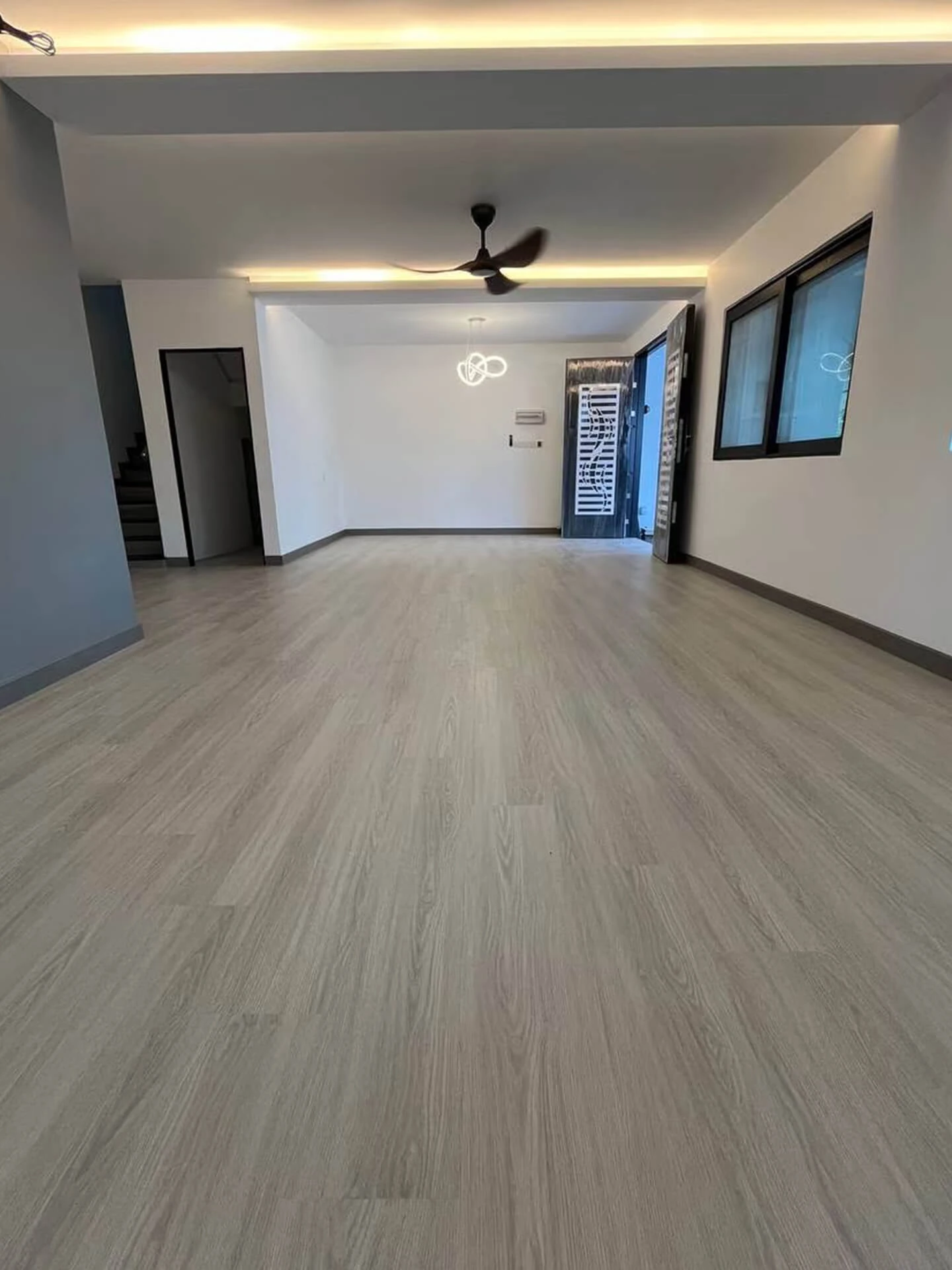 Professional team installing SPC flooring across a large commercial space