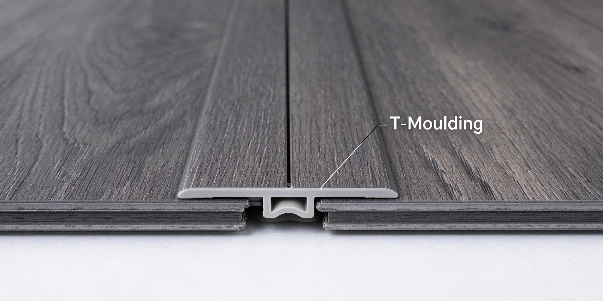 SPC T-moulding connecting two flooring surfaces at the same height